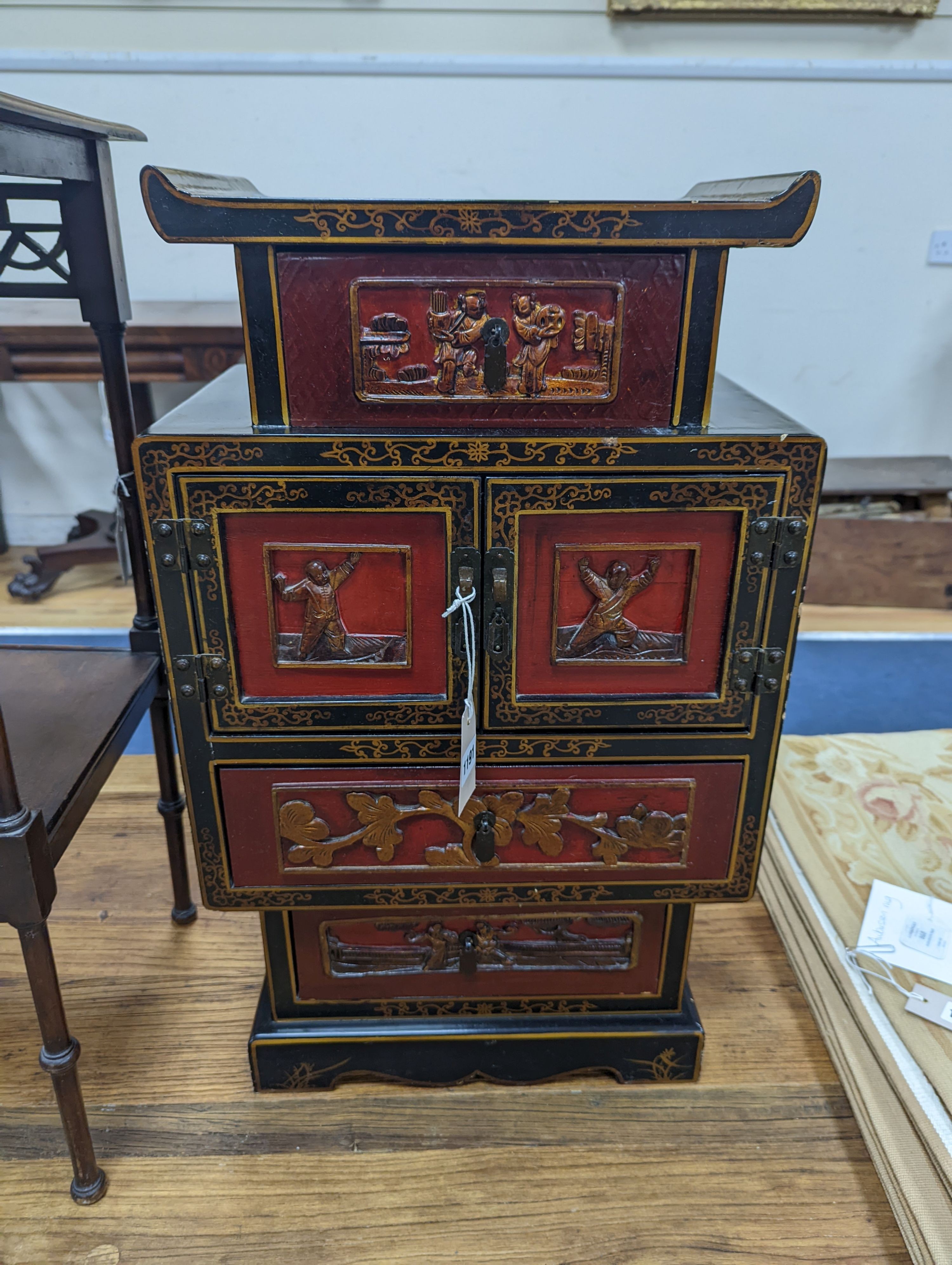 A late 19th century Chinese red and black lacquered cabinet, width 39cm, height 66cm